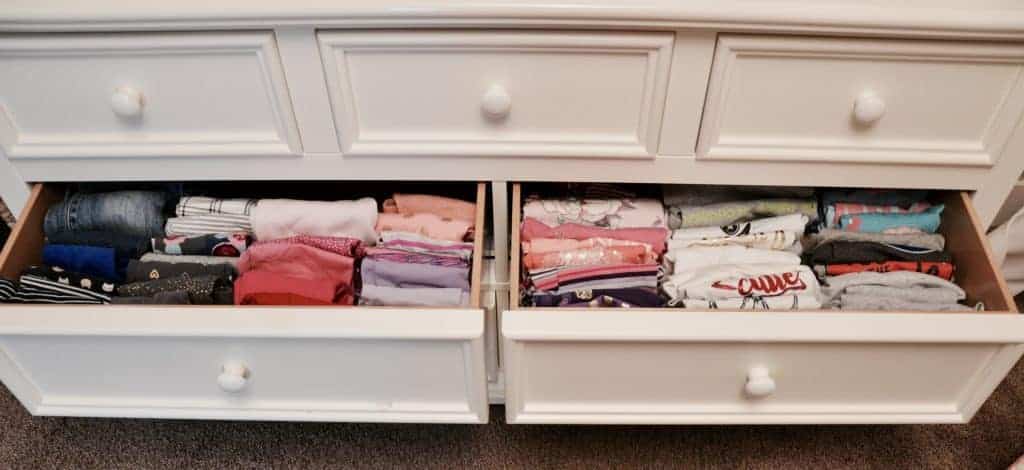 Pants drawer and shirt drawer with neatly folded vertically filied clothes.