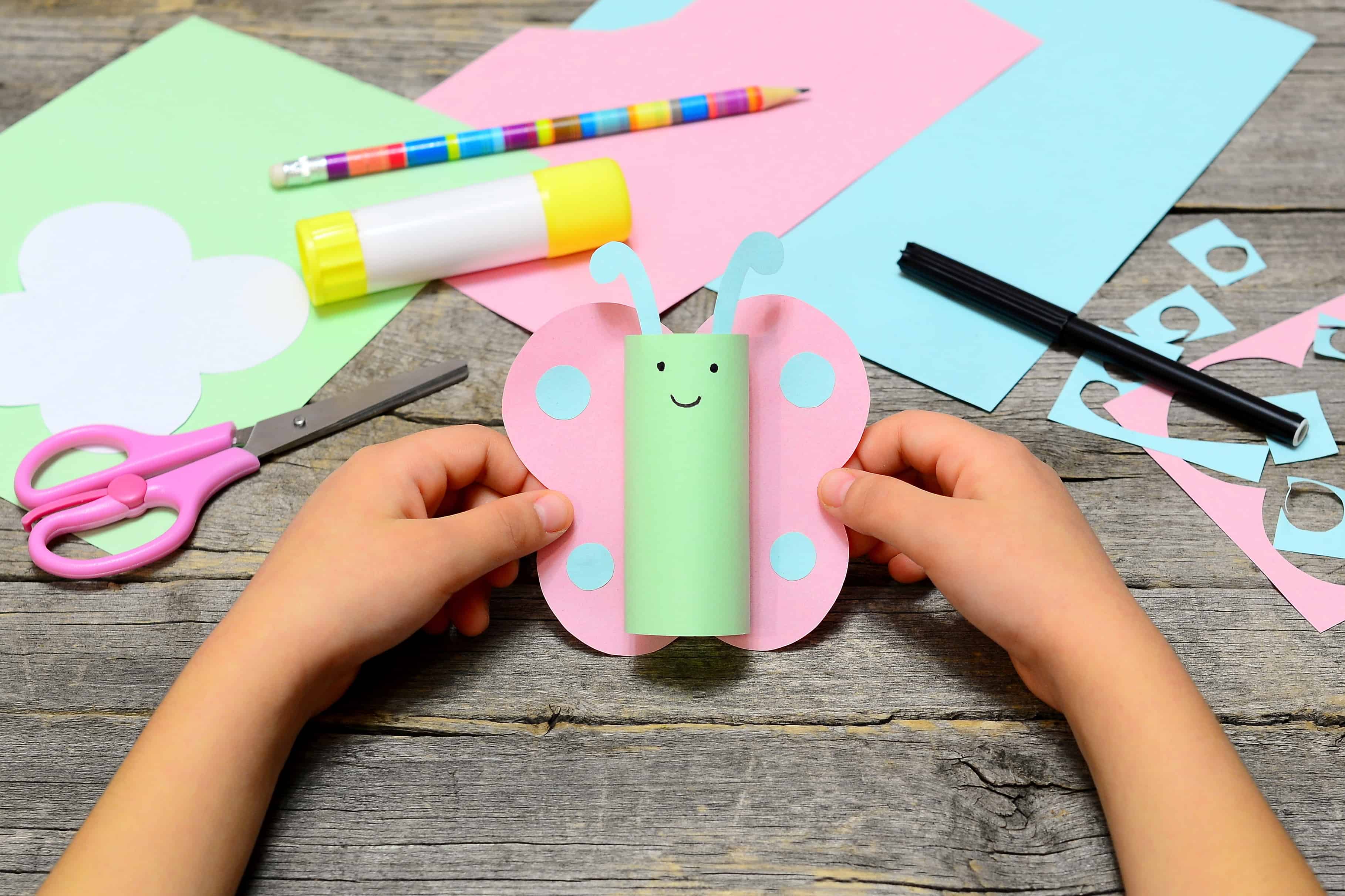 Preschooler craft with paper, scisors, and glue.