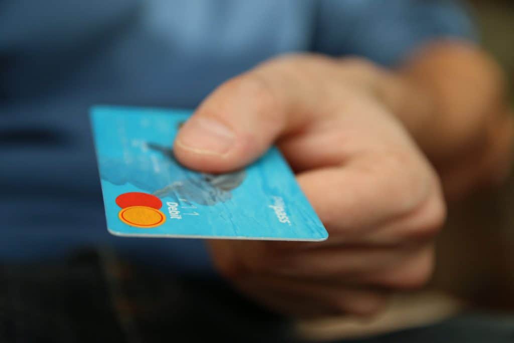 man's hand holding a credit card