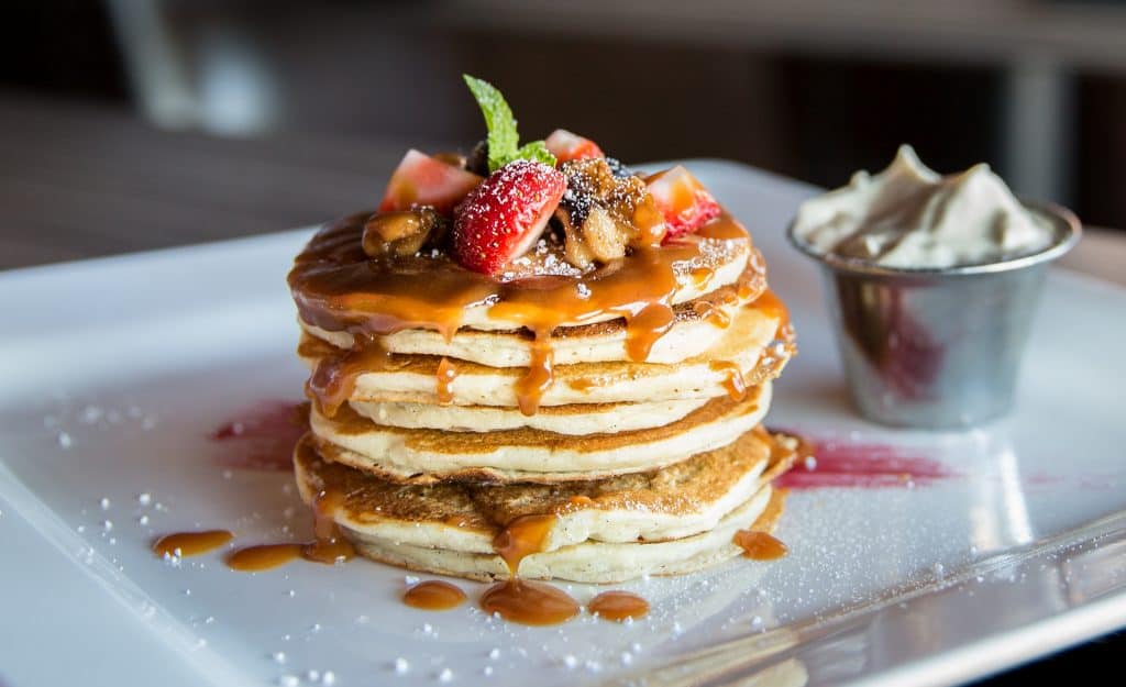 stack of pancakes with fruit on top