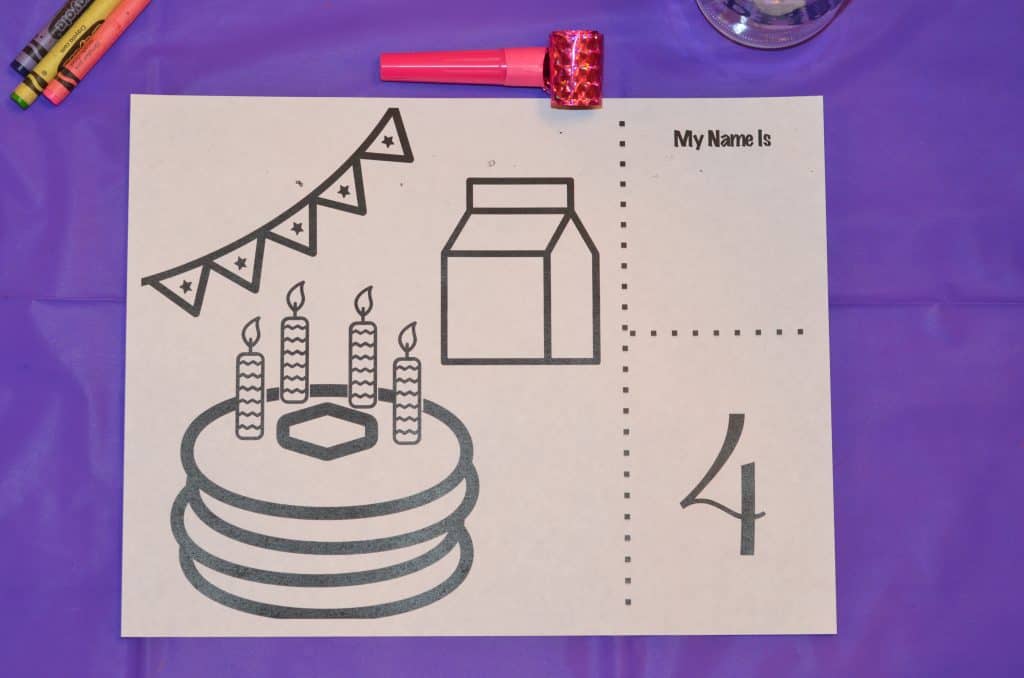 Birthday party coloring page with pancakes, candles, banners, and milk.