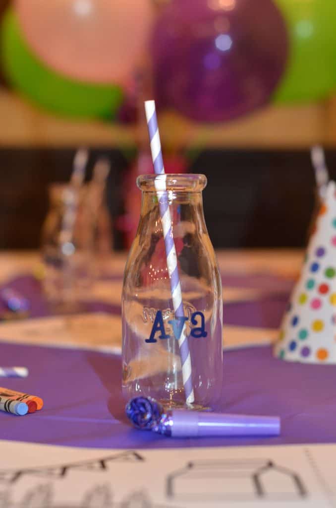 close up of a milk jug customized with party guests name.