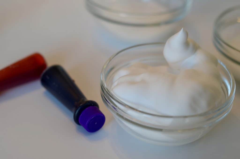 food coloring next to a small bowl of shaving cream