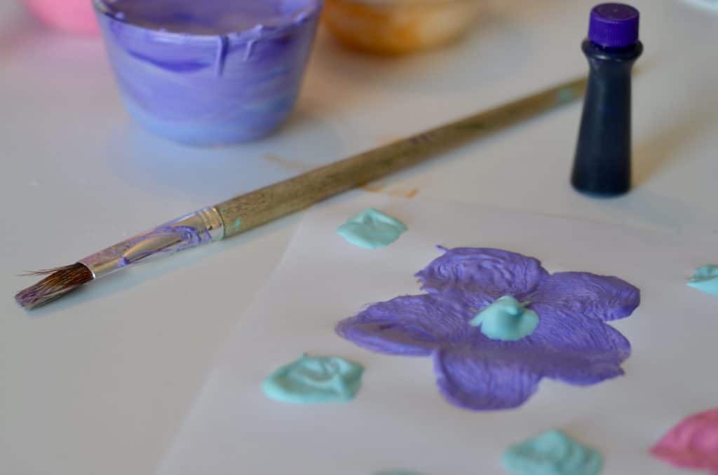 close up of a purple puffy paint flower