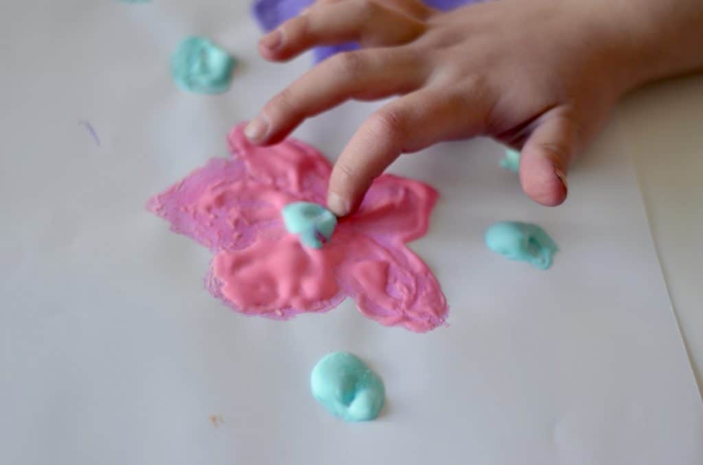 Close up of a preschooler's hand touching dried puffy paint