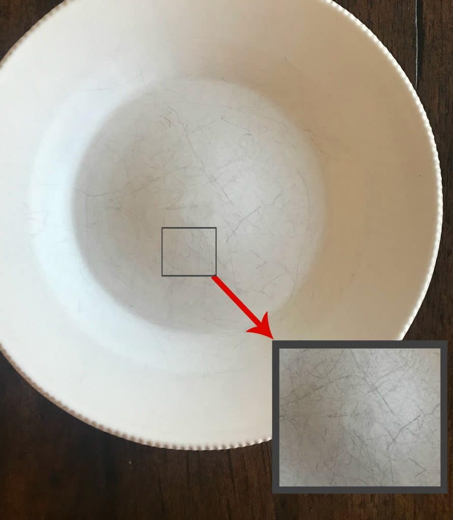 a scratched dish with a square showing an enlargement of the scratched area