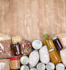 Pantry Food samples on wooden background, top view with copy space