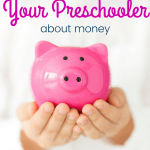 Preschooler hands holding a piggybank with text 8 ways to teach your preschooler about money
