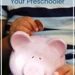 Piggy bank with a young hand placing a coin in it and text - financial principles you can teach your preschooler
