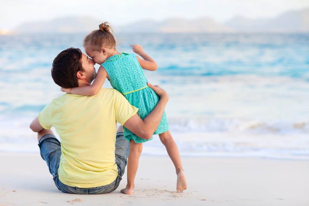 Happy father and daughter at beach