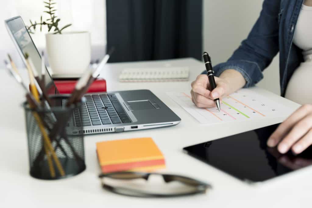 Calendar planner agenda schedule concept. Woman working in her office, working, planning.