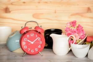 Vintage background with retro alarm clock on table