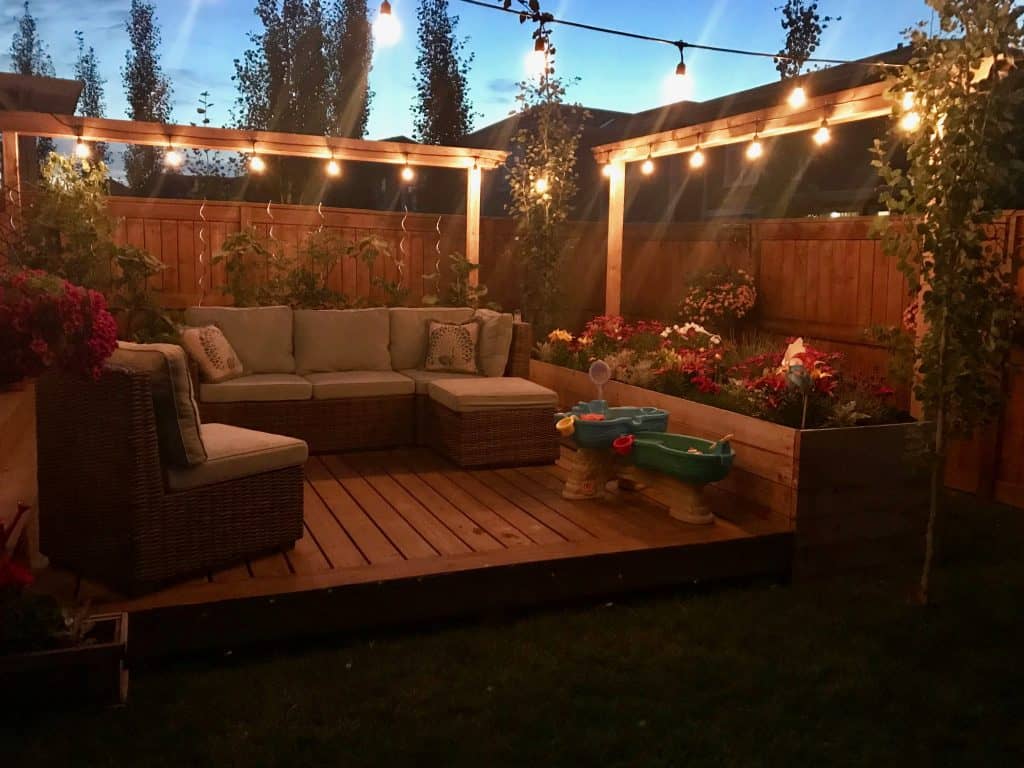Backyard with flower and vegetable garden and string lights