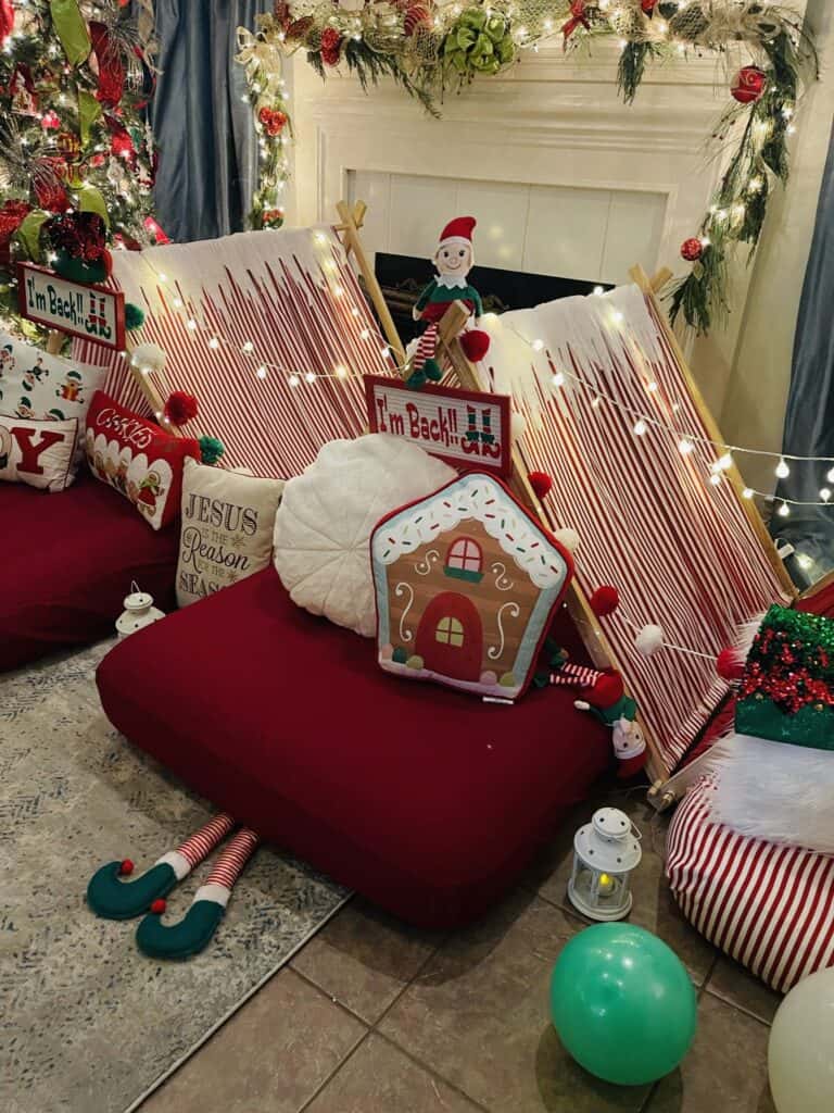 Holiday room with candy cane striped tents, stuffed elves, and holiday pillows as the family gathers to experience a stress free holiday.