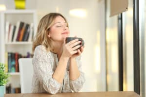Woman who loves her clutter free home after decluttering.