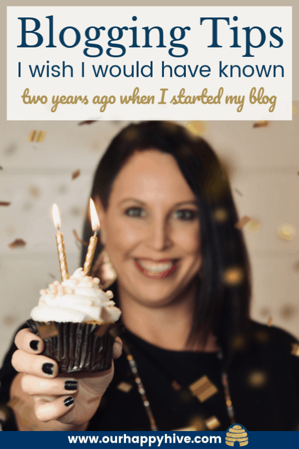 girl holding up a cupcake with two candles and confetti in the air with text blogging tips I wish I would have known two years ago when I started my blog