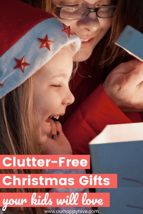 excited girl looking into an open christmas present with text clutter-free christmas gifts your kids will love