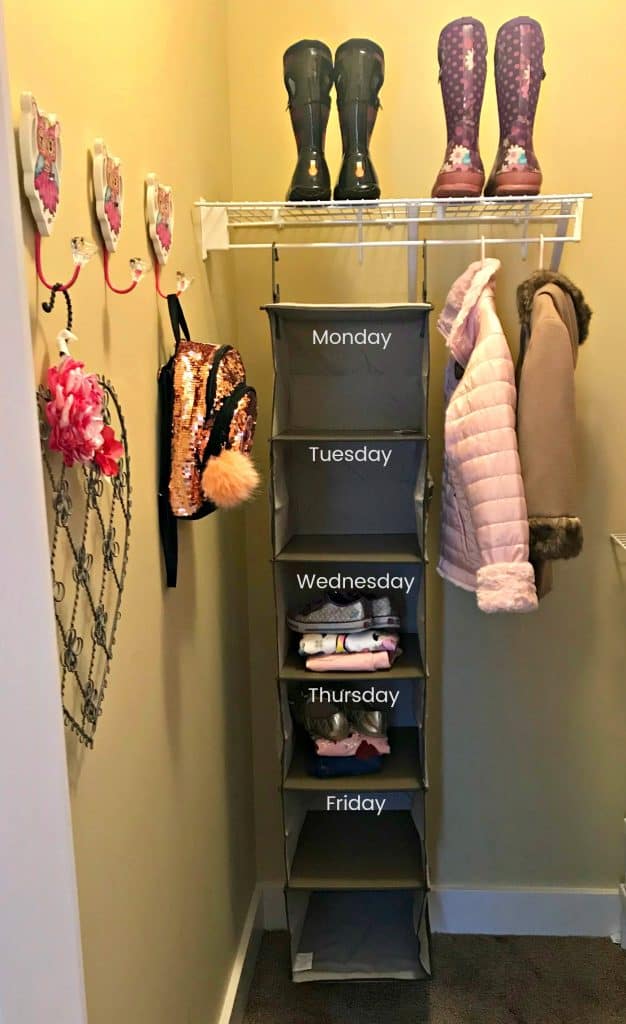 hanging shelf with kids clothes for each day of the week