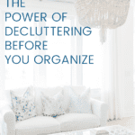 Image of a white couch and decluttered coffee table in front of a bright window. With text from Chaos to Calm: the power of decluttering before you organize.