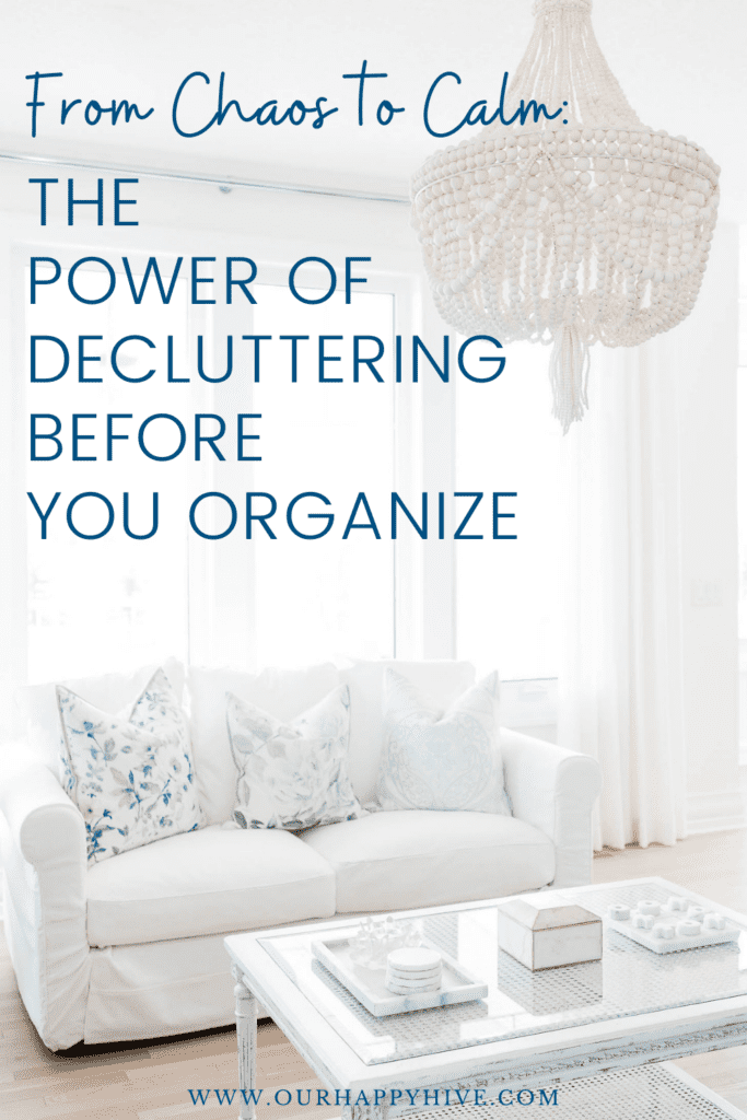 Image of a white couch and decluttered coffee table in front of a bright window. With text from Chaos to Calm: the power of decluttering before you organize.