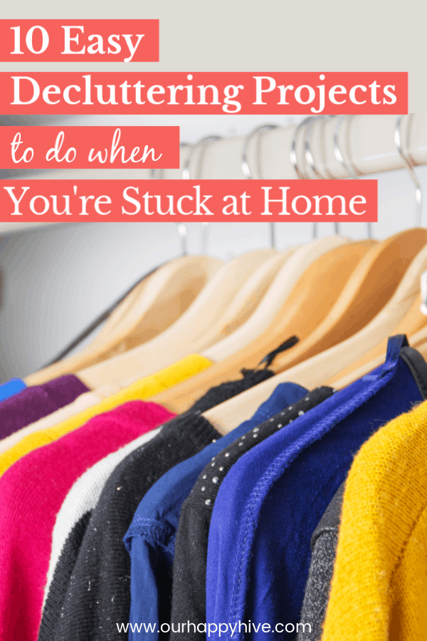 Decluttered closet with sweaters neatly hung up with text 10 Easy Decluttering Projects to do when You're Stuck at Home