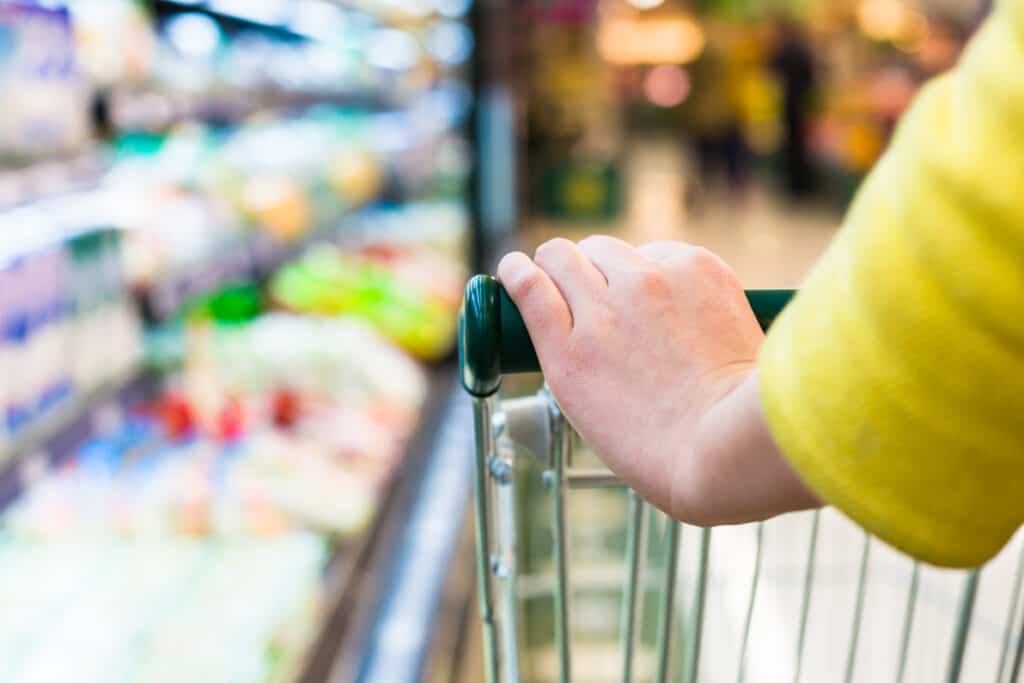 woman shoping by aisle with her free grocery list printable