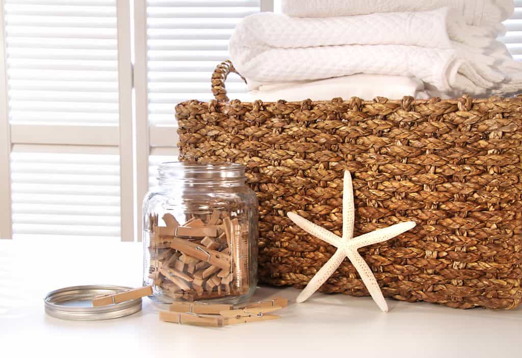 Closeup of laundry basket with fine linens on table