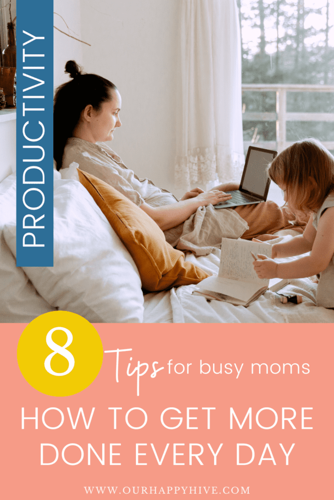 Busy mom working on a computer while sitting on her bed with a child playing beside her. Text includes 8 tips for busy moms, how to get more done every day.