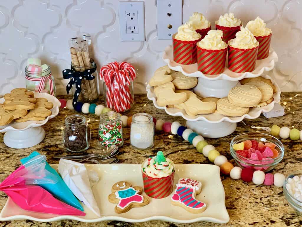 diy christmas cookie bar with topings and icing for guests to decorate