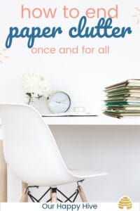 Picture of a tidy desk with a stack of organized paperwork on the corner and text how to end paper clutter once and for all.