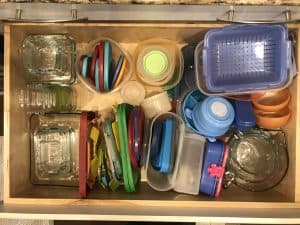 disorganized food storage containers in a drawer