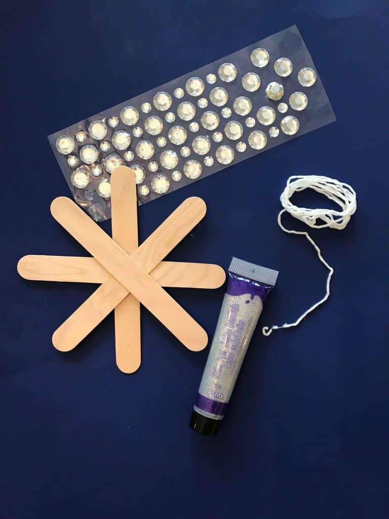 popsicle sticks, paint, adhesive rhinestones, supplies for snowflake craft