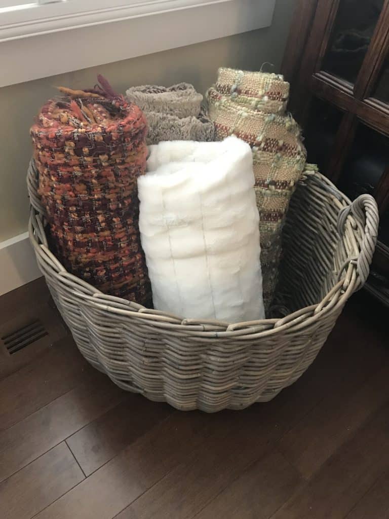 blankets neatly rolled and placed in a basket.