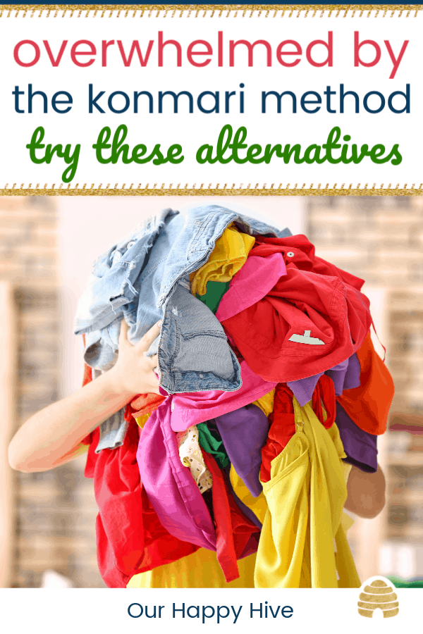 Woman holding pile of colorful clothes indoors with text overwhelmed by the konmari method try these alterntives