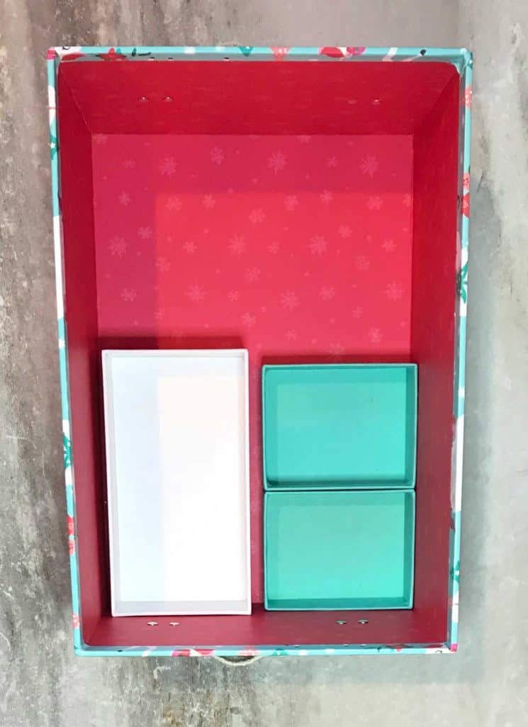 inside of shoe box colored pink, with three boxes fitting inside of it to compartmentalize sections