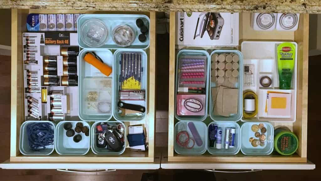 side by side two organized drawers with containers for each item in the drawer