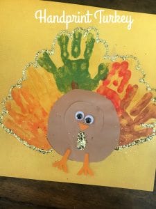 Turkey with multi-colored handprints and glitter outline.