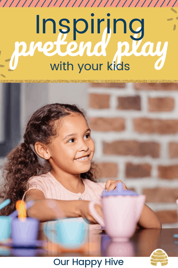 young girl smiling with a play tea set in front of her and text Inspiring pretend play with your kids