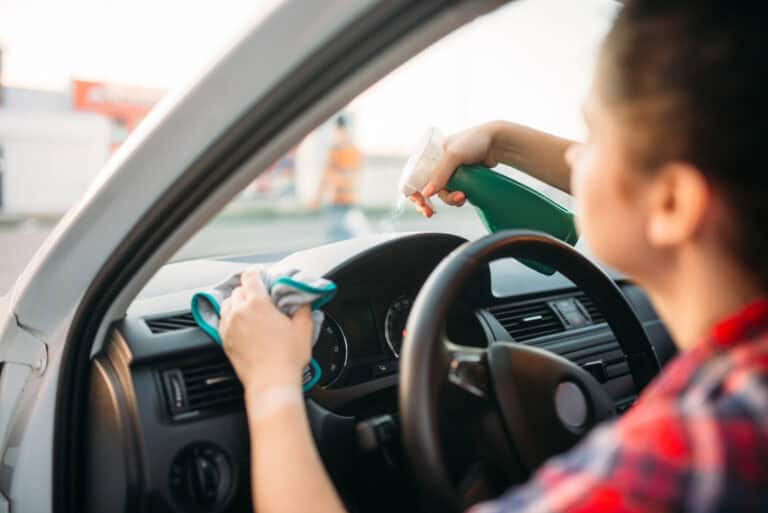 woman cleaning the inside of her car