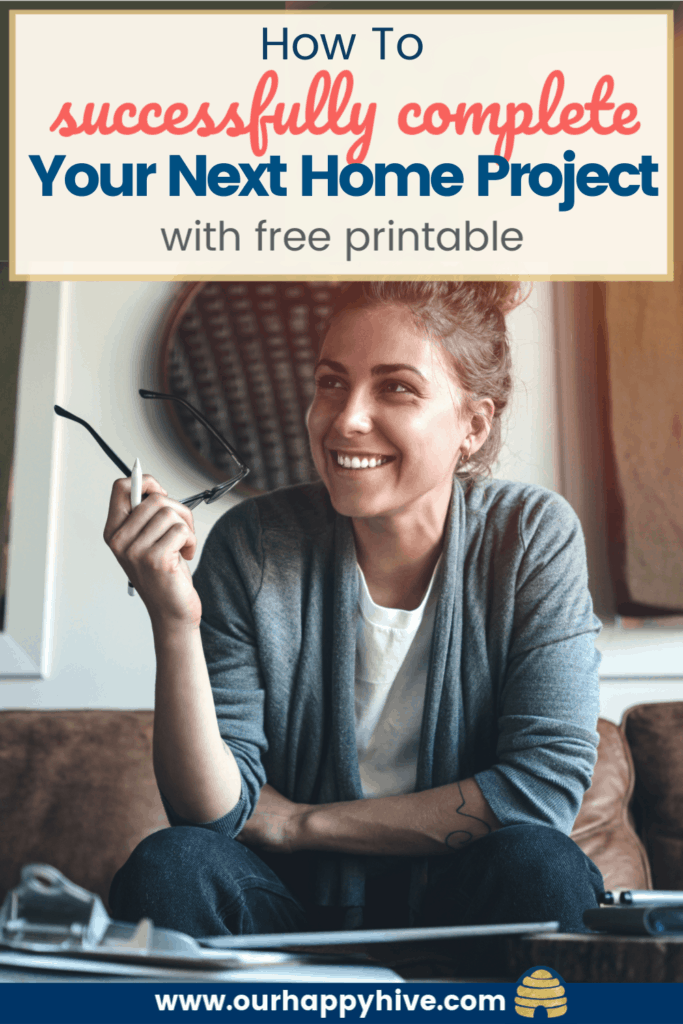 Woman thinking bout her next home improvement project. Working on a project plan to reduce overwhelm and actually complete the project. Woman sitting at a desk with a smile on her face with text how to successfully complet Your Next Home Project with free printable.