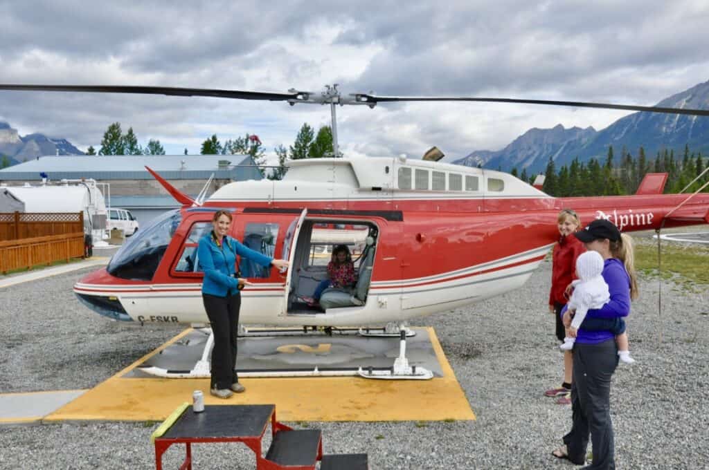 Woman opening the door to a helicopter as an experienced-based clutter free gift.