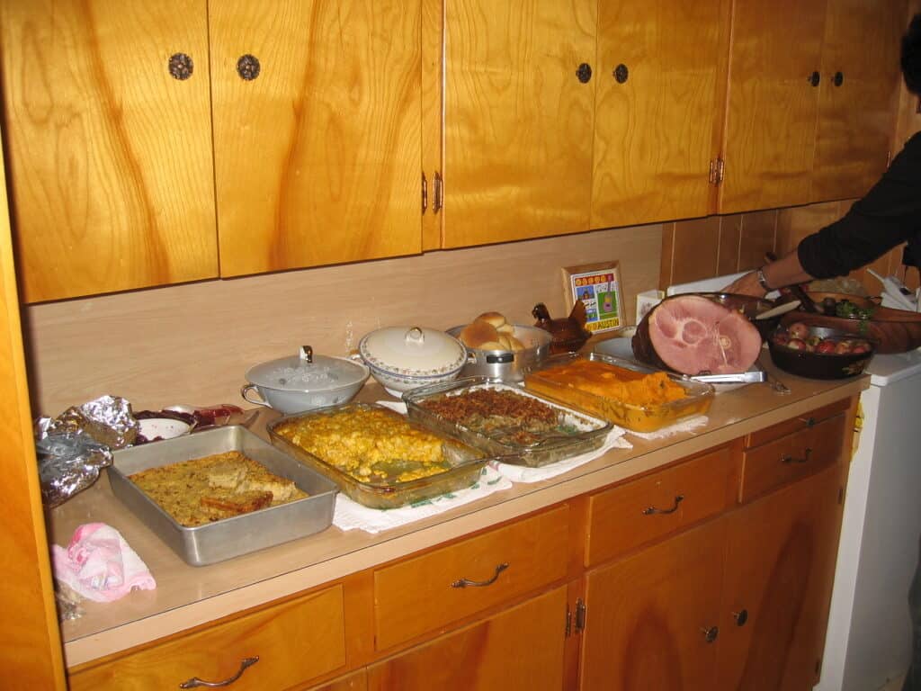 Buffet filled with cassaroles and meat dishes for thanksgiving dinner.