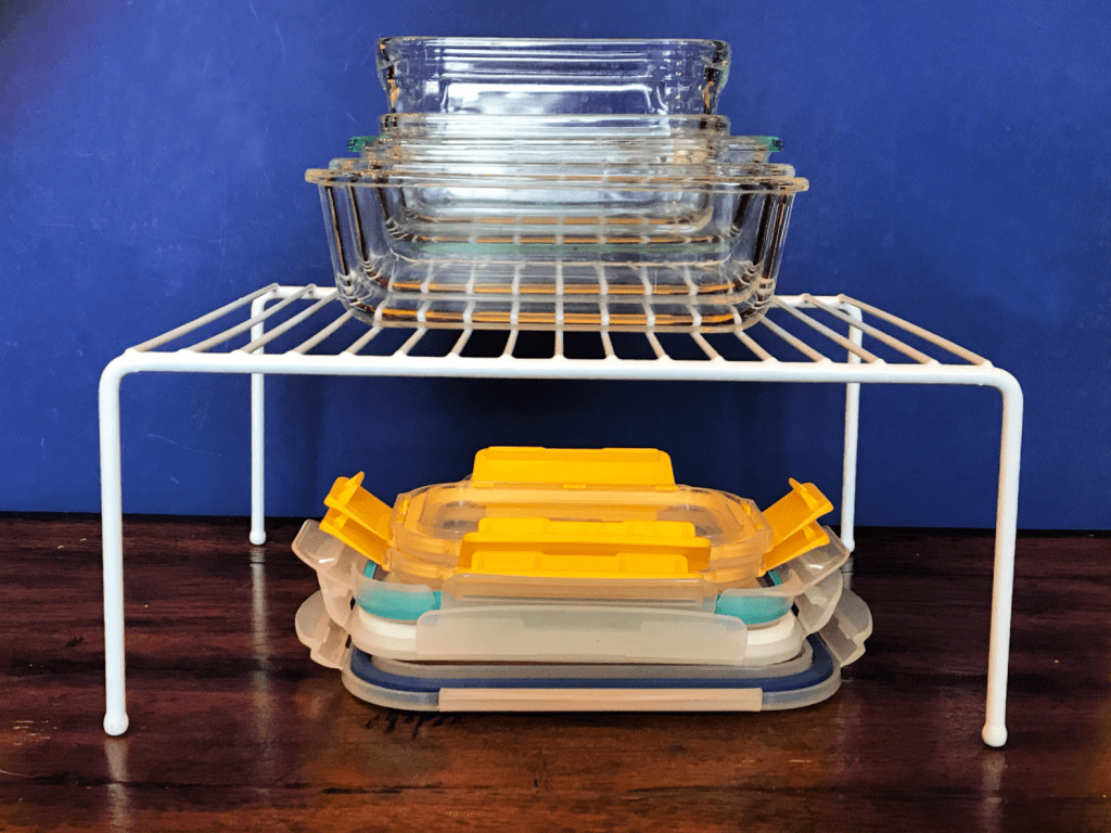 Wire shelf with lids on the bottom and glass containers on top