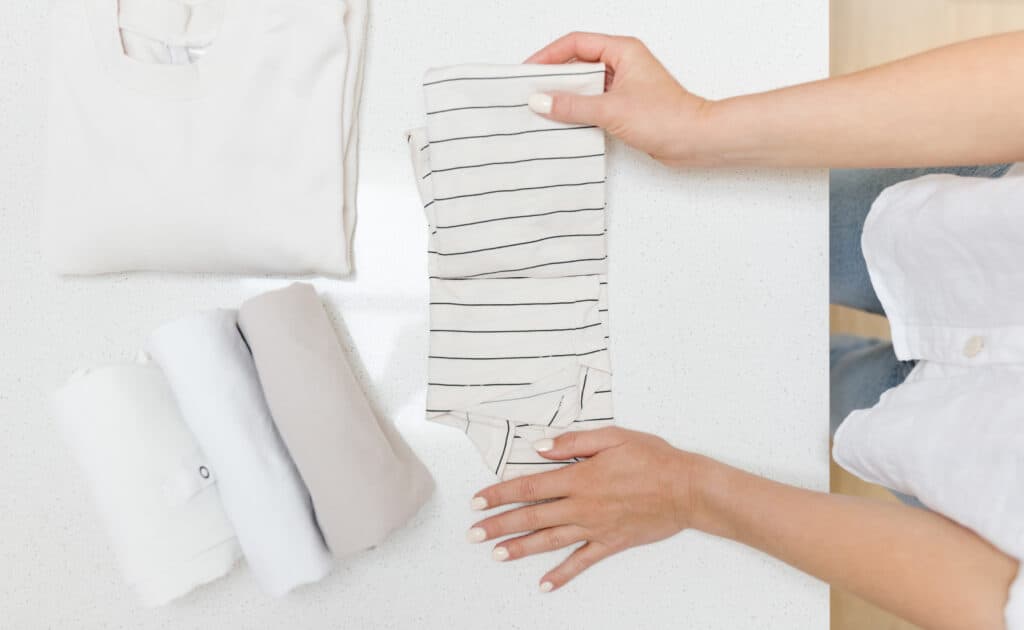 Picture of a woman folding clothes with the vertical filing method.