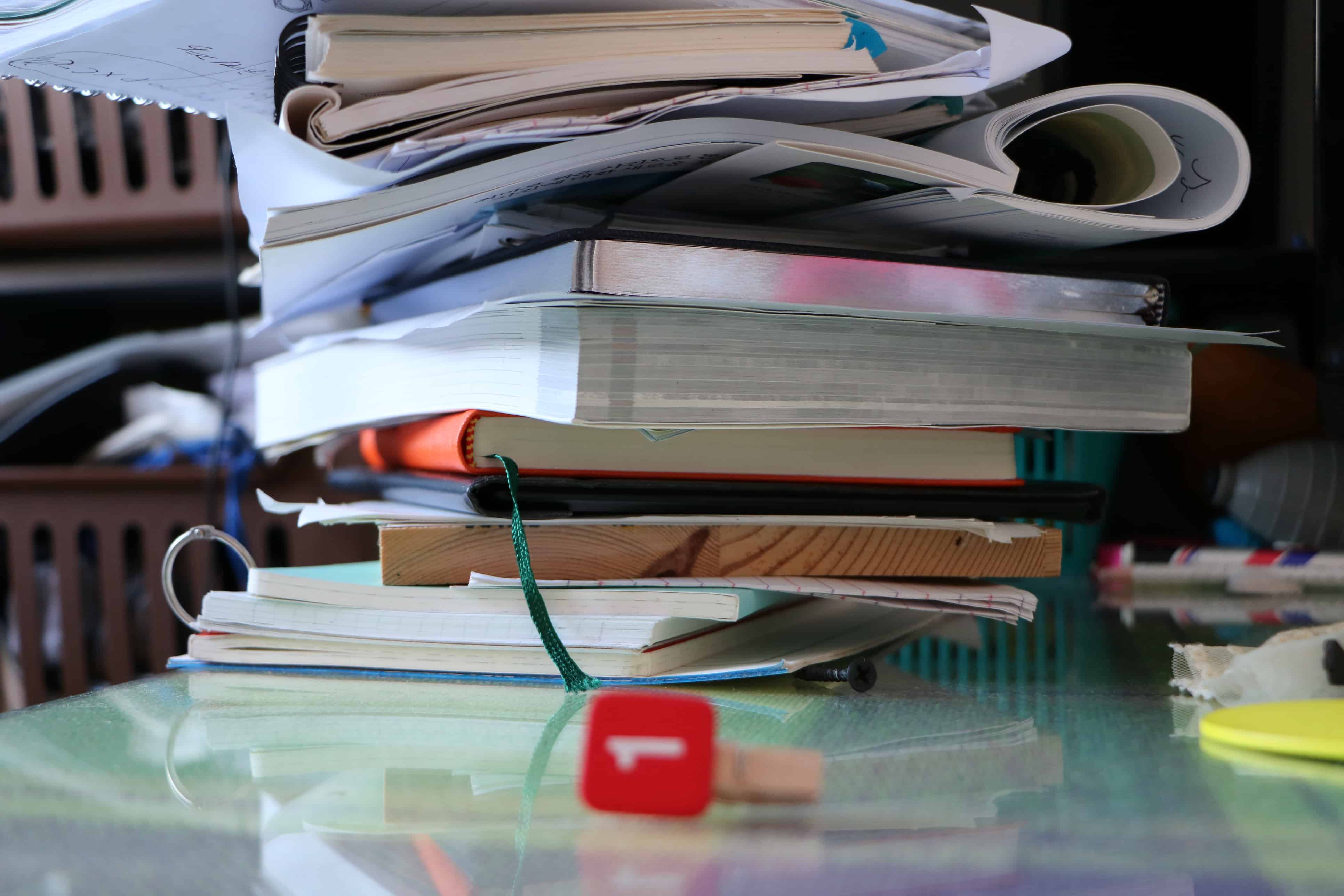 a pile of papers and books that has become clutter