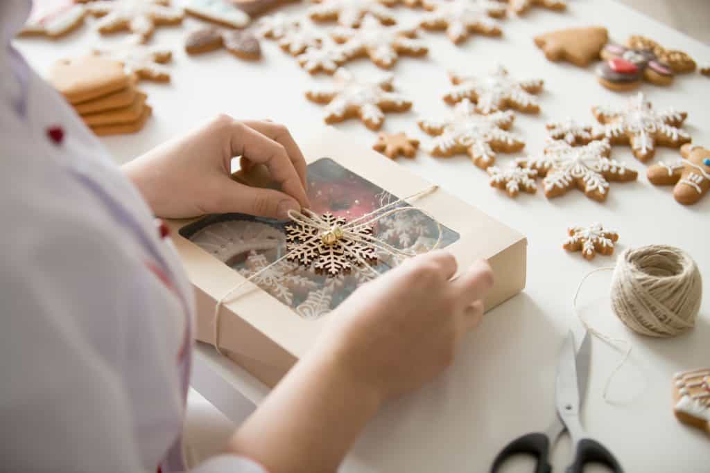 Woman wrapping christmas cookies