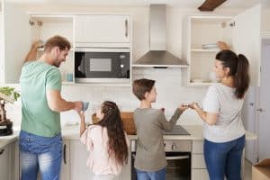 A family working together to organize their kitchen