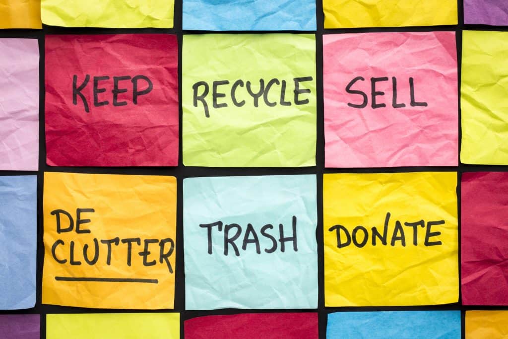 declutter concept (keep, recycle, trash, sell, donate - handwriting on color sticky notes